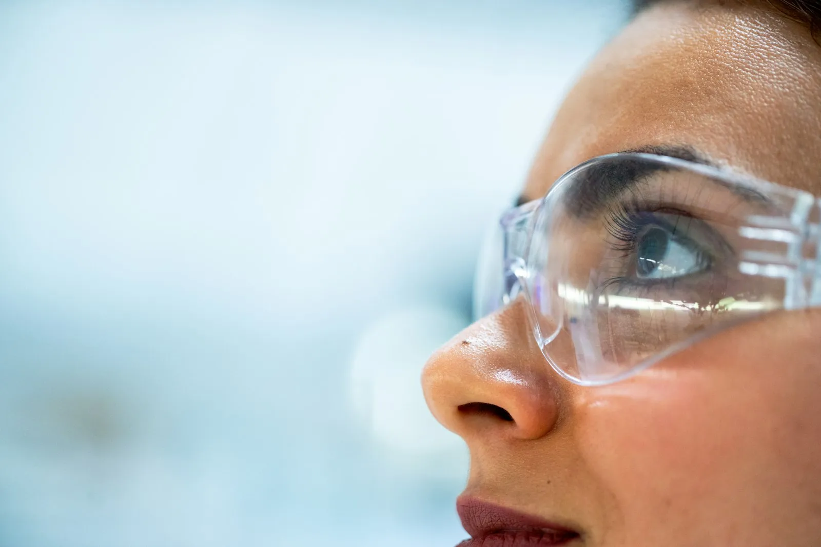 Worker wearing safety glasses on an industrial site
